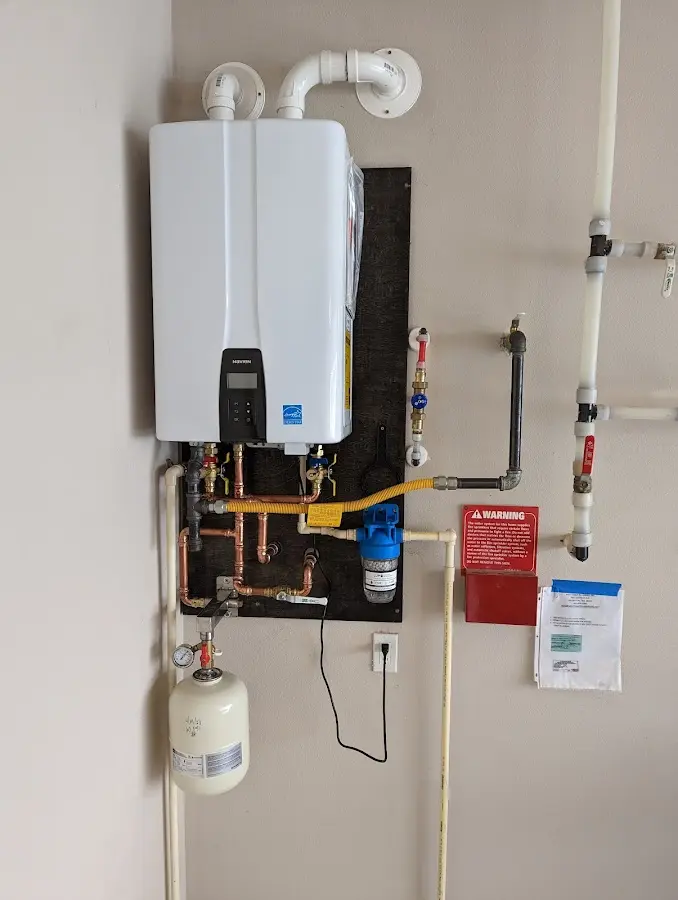 Professional plumber installing copper piping in a North Aurora home